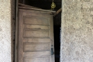 Broken door - stuccoed walls