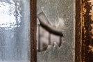 Rusted door frame with broken glass