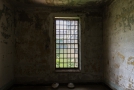 Large window with two lighting fixture covers on the floor
